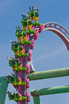 Rollercoaster loop against a brilliant blue sky