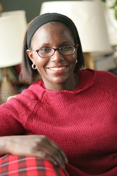 Beautiful African American woman reclining on couch