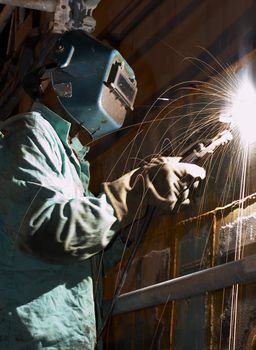 a welder working at shipyard during night shift