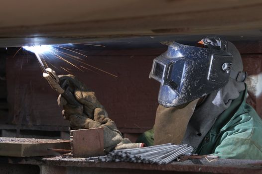 a welder working at shipyard during night shift