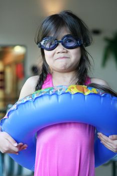 Girl with swimsuit and floatie ring ready for summer