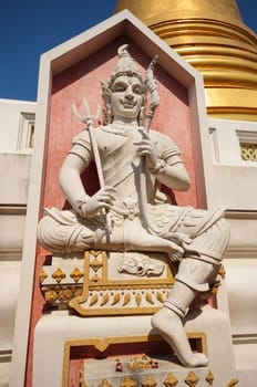 statue and golden pagoda at thai temple
