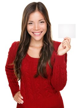 showing woman presenting blank gift card sign. Happy smiling Asian woman in red winter sweater isolated on white background.
