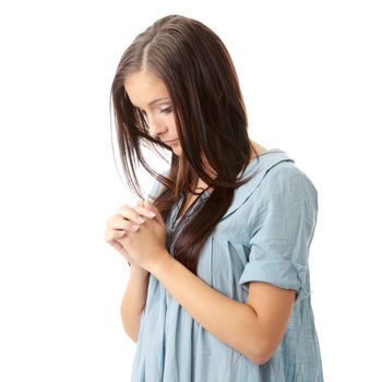 Closeup portrait of a young caucasian woman praying isolated on white background