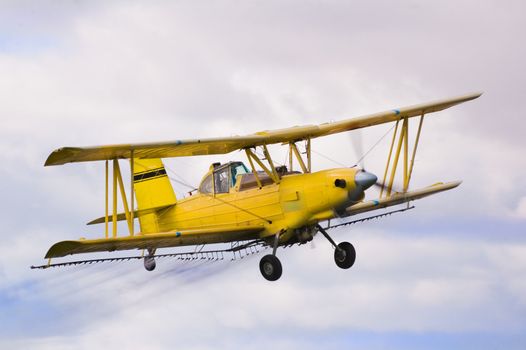 crop duster spraying insecticide on crops in central California