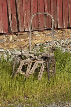 An old weathered and abandoned wheelchair on a farm in Sutter Creek, California
