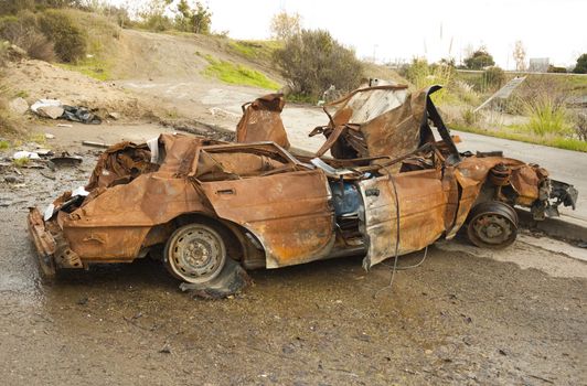 Burnt wreck of a car in a cul de sac