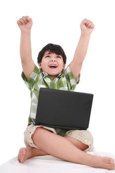 Happy little boy with laptop with moving apart his hands - indoors