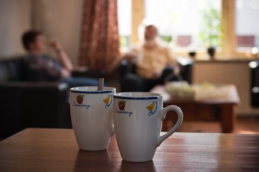 Moment relaxing in the afternoon with a coffee break - coffee mugs in foreground