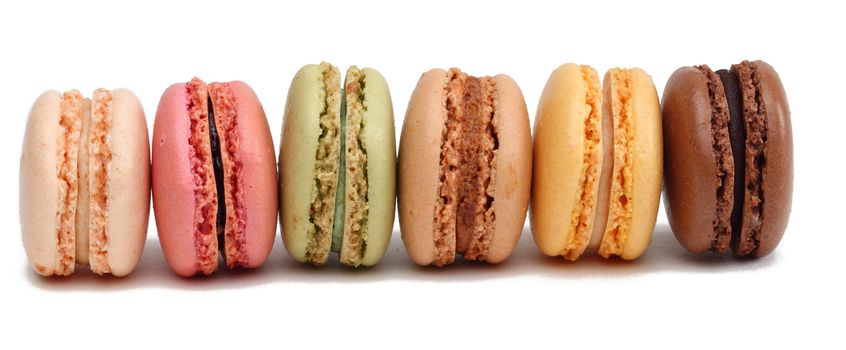 Row of colorful macarons against a white background.