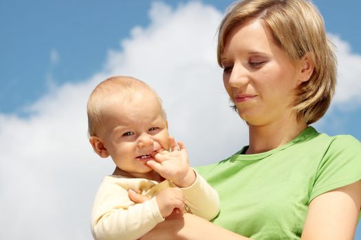 Mother with baby under blue clear sky