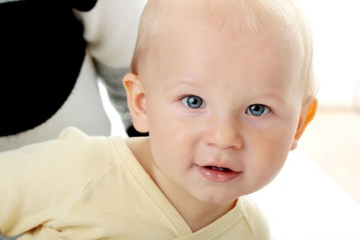 Bright closeup portrait of adorable baby boy and his mom