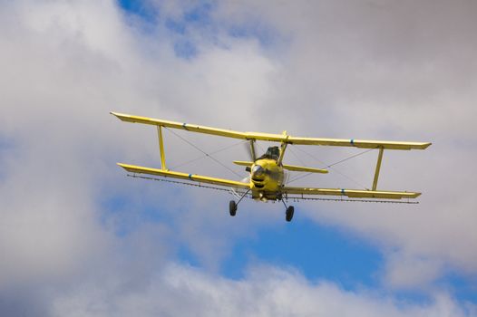 Crop dusting aircraft spraying fields