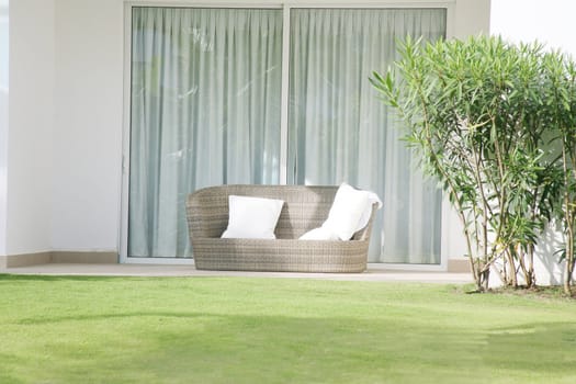 A large chair cushion in front of a large open window