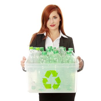 Young businesswoman carrying a plastic container full with empty recyclable household material. Recycling concept