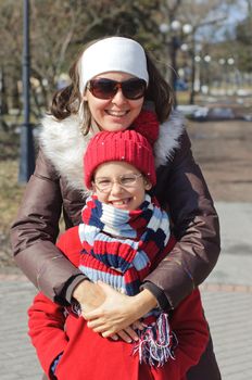 Happy mom with a daughter for a walk in the Spring Park