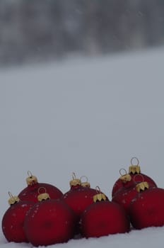 a red bauble in snowy lwinter andscape