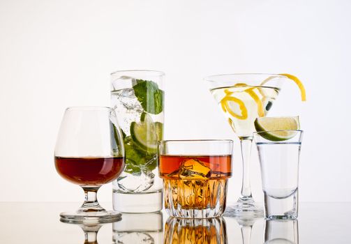 Various cocktails and alcohol on white background