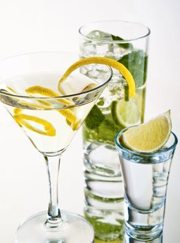 Various cocktails and alcohol on white background