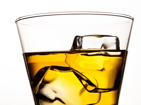 Whiskey on the rocks in an old fashion glass isolated on white