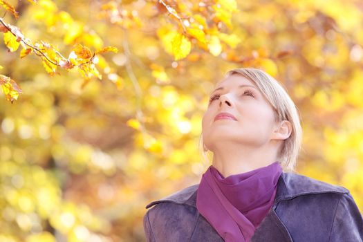 Beautiful young woman in autumn forest