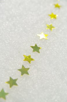 golden snow stars on a real snowy icy surface