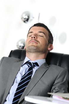 Attractive businessman is sleeping a while  from business
