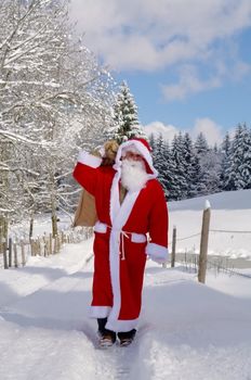 Santa Claus, Father Christmas in a beautiful winter landscape