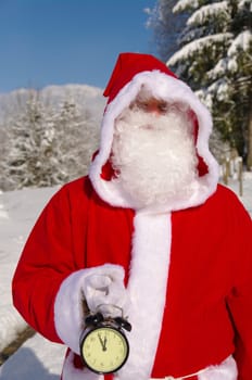 Santa Claus, Father Christmas holds watch clock