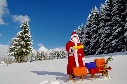 Santa Claus, Father Christmas with colorful presents on a sledge