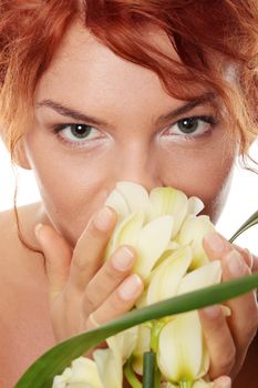 Beautiful young woman smelling orchid flower. Spa concept