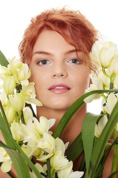 Beautiful young woman with orchid flower. Spa concept
