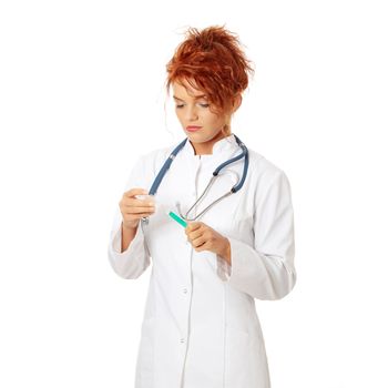 Young female doctor or nurse holding syringe , isolated on white.