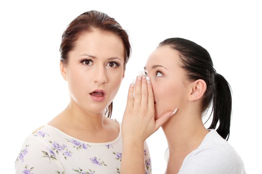 Two happy young girlfriends talking over white