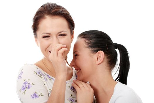 Two happy young girlfriends talking over white