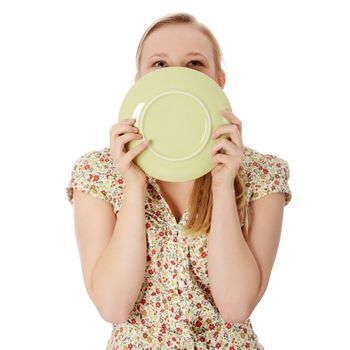 Casual blond woman licking plate