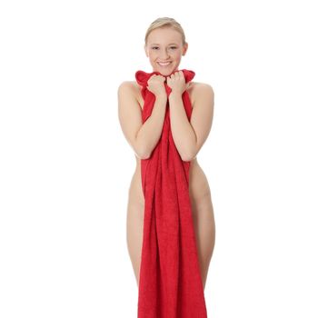 Attractive young nude woman covered by red towel, isolated on white