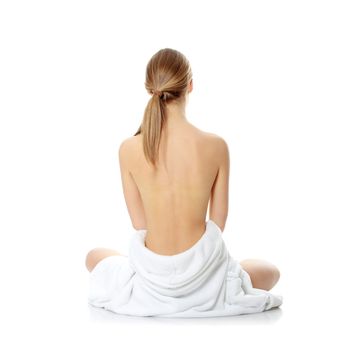 Portrait of young beautiful topless caucasian woman with blue towel on her waist isolated on white background