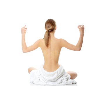 Portrait of young beautiful topless caucasian woman with blue towel on her waist isolated on white background 