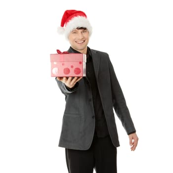 Handsome businessman offering a christmass gift. Isolated on white background