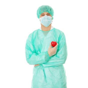 Handsome young male doctor holding heart shape toy, isolated on white