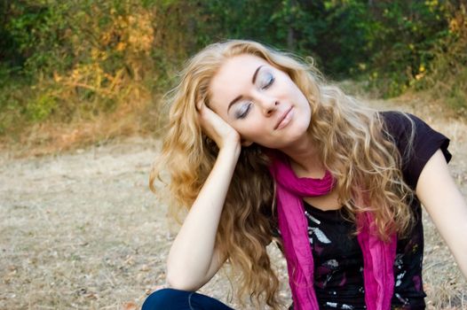 Woman relaxing on fall background eyes closed