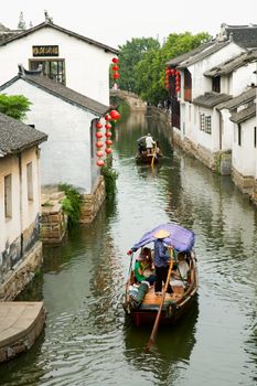 The aerial view of water town in China, with boat man rowing on river