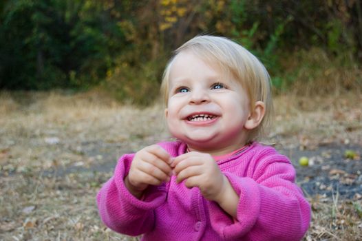 Happy smiling baby girl looking up