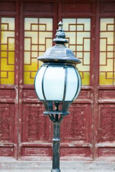 The classic lamppost in temple with antique door as background