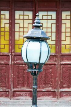 The classic lamppost in temple with antique door as background