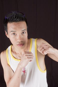 closeup of a young asian man on a black background