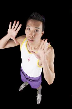closeup of a young asian man on a black background holding hands up shot from above