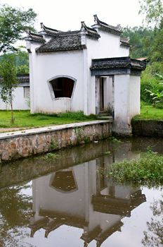 The Chinese architecture with reflection over lake in garden, jiangxi