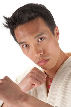 Young asian man in an Aikido, judo, Karate outfit isolated on a white background